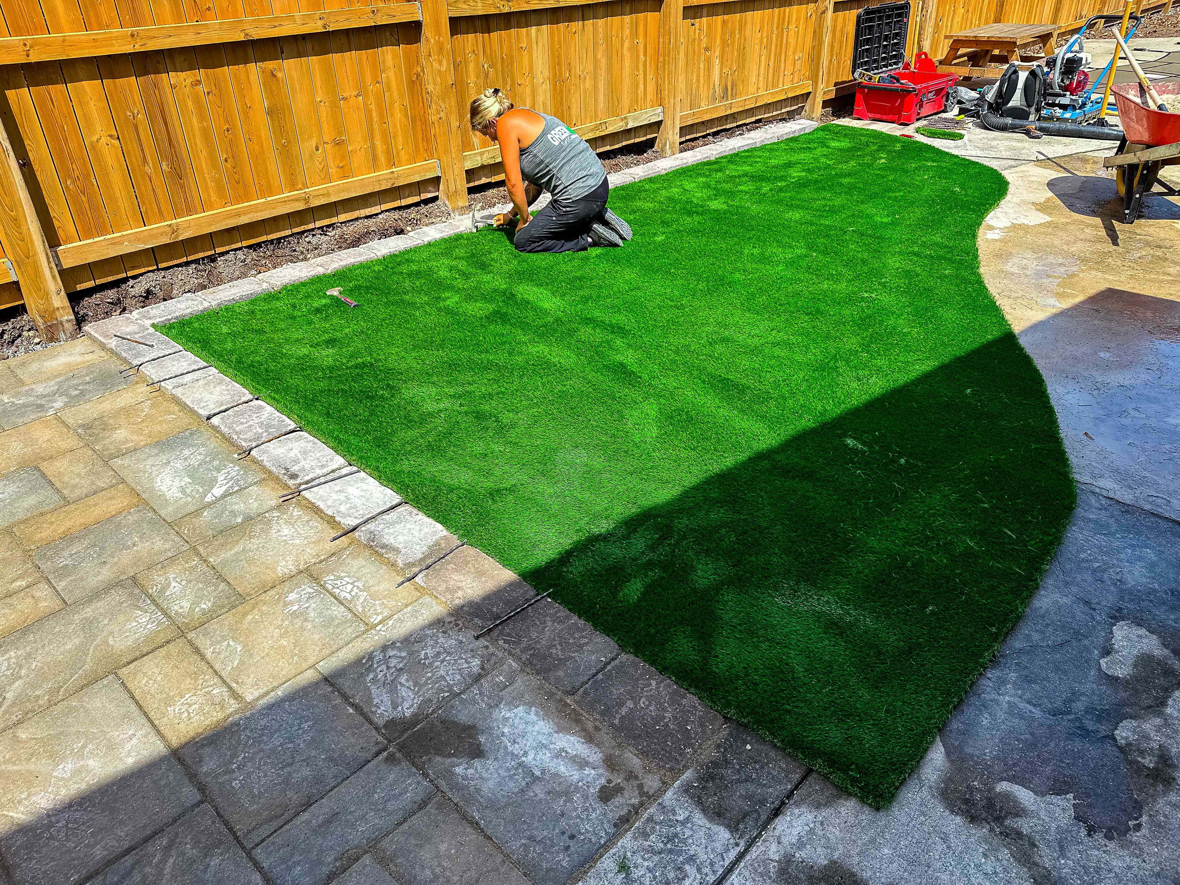 Artificial turf installation in backyard