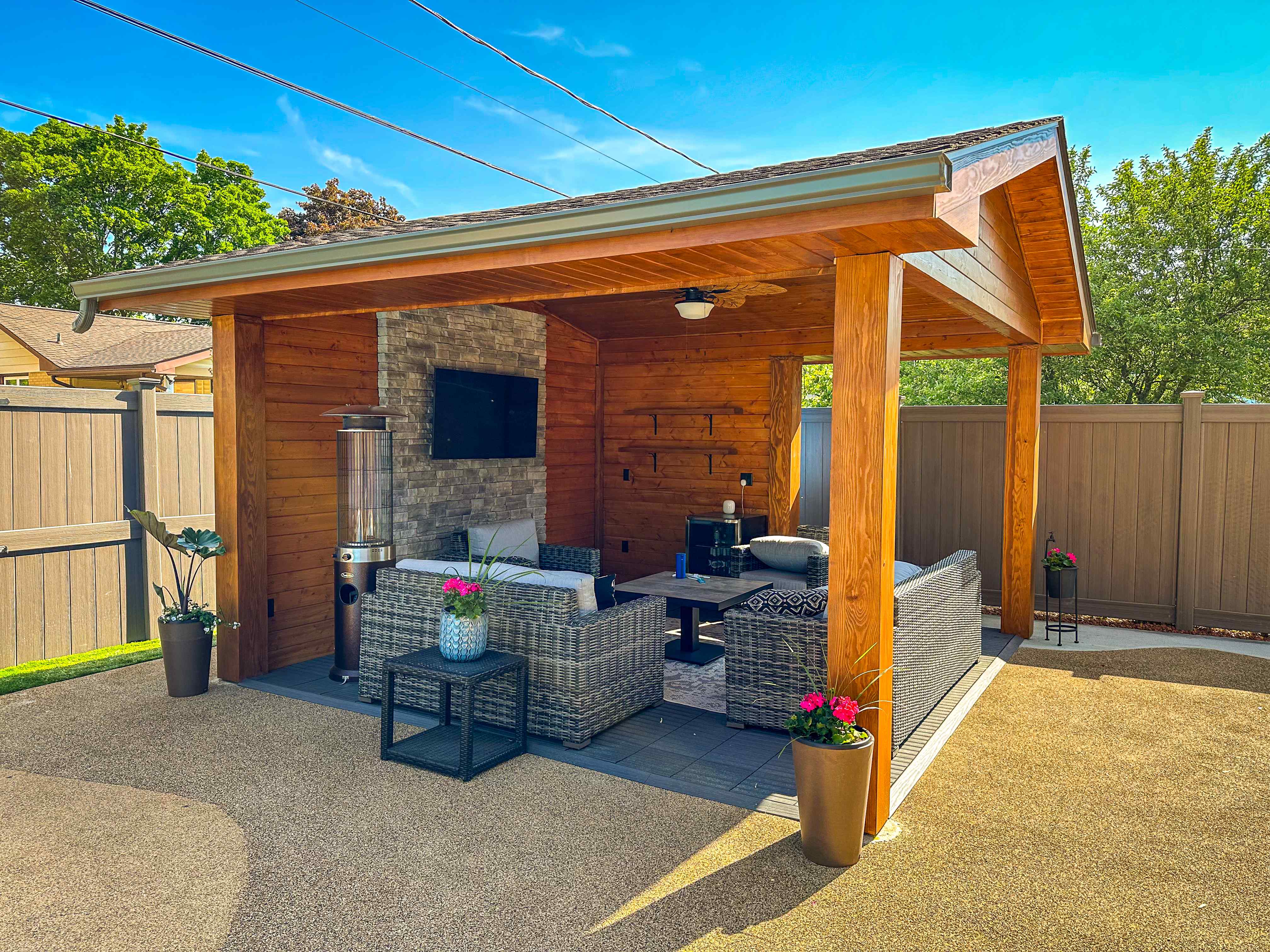 Custom backyard pavilion with stone fireplace