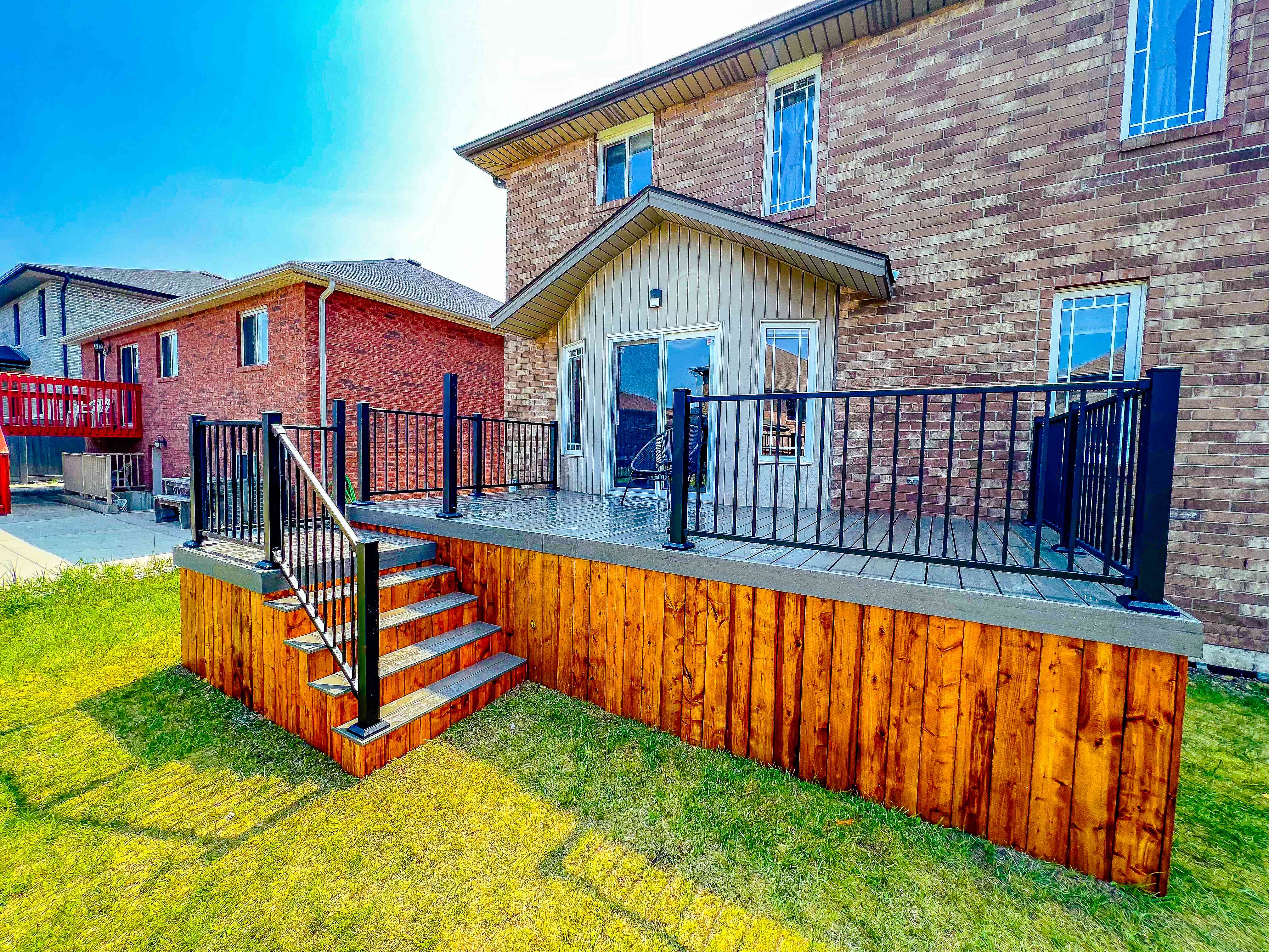 Elevated deck with wooden skirting and black railings