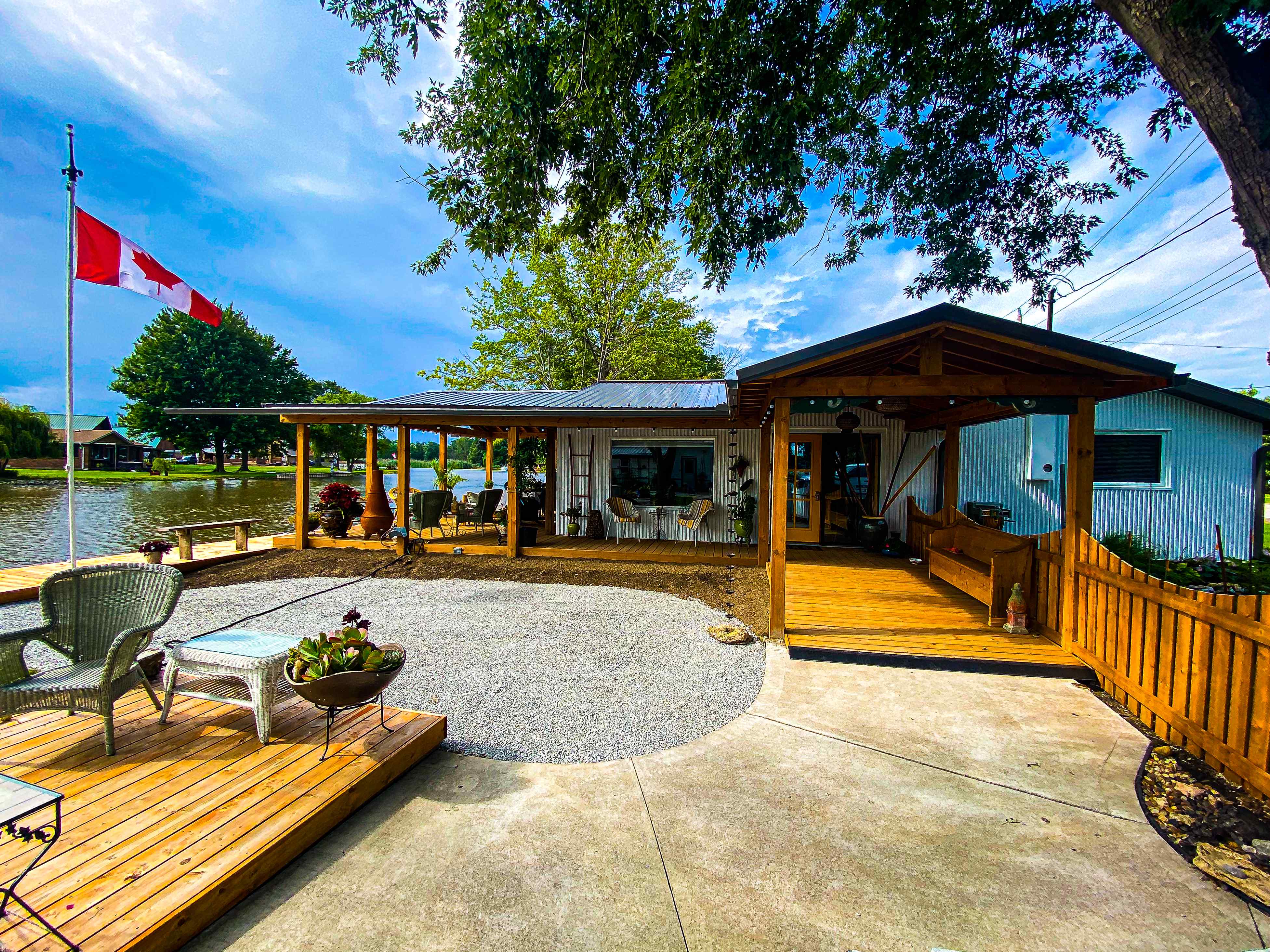 Waterfront cottage with extensive wooden decking and pergola