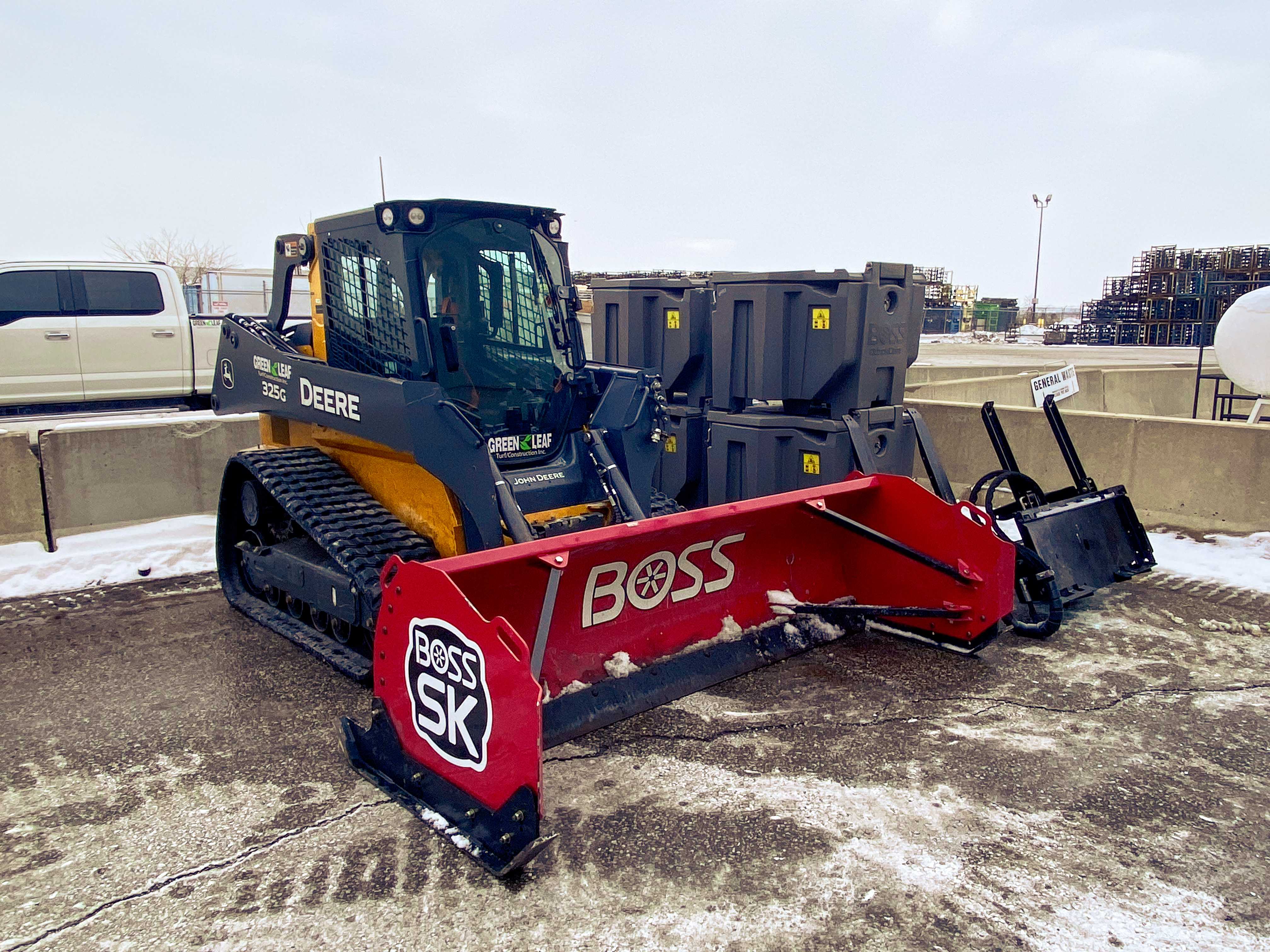 Green Leaf John Deere skid steer with Boss snow plow attachment